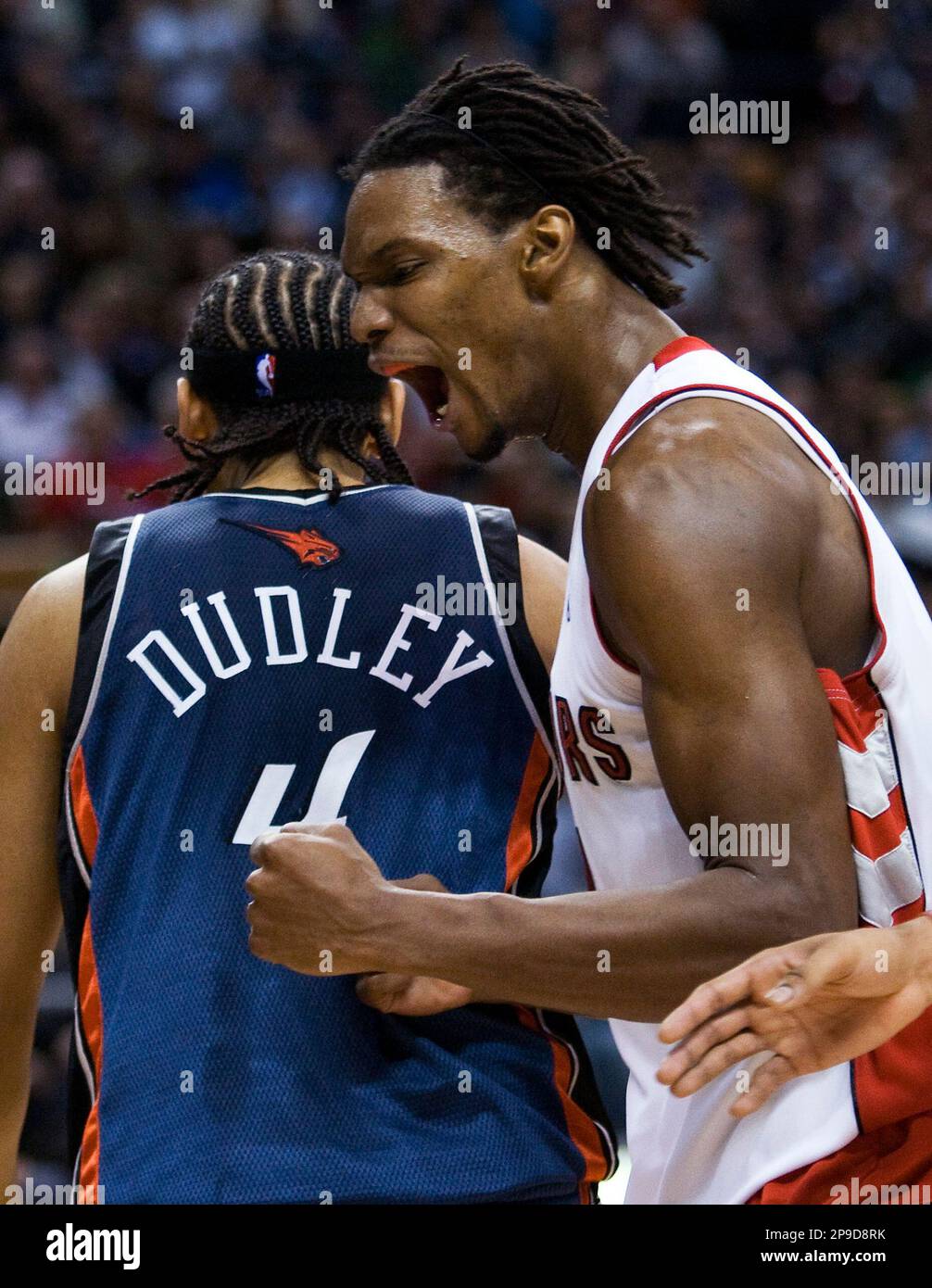 Toronto Raptors' Chris Bosh, right, reacts after a play as Charlotte Bobcats' Jared Dudley walks past during the second half of an NBA basketball game in Toronto on Wednesday, Nov. 26, 2008. (AP Photo/The Canadian Press, Nathan Denette) Stock Photo
