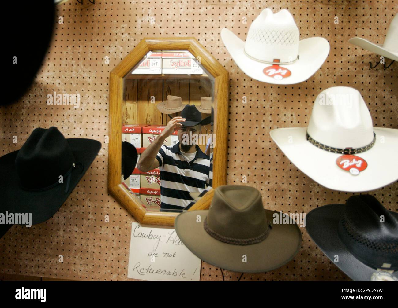 Angel Gomez tries on cowboy hats at the Olsen Nolte Saddle Shop in San  Carlos, Calif., Monday, May 12, 2008. Since Gomez was spending a fair  amount of time riding horses as