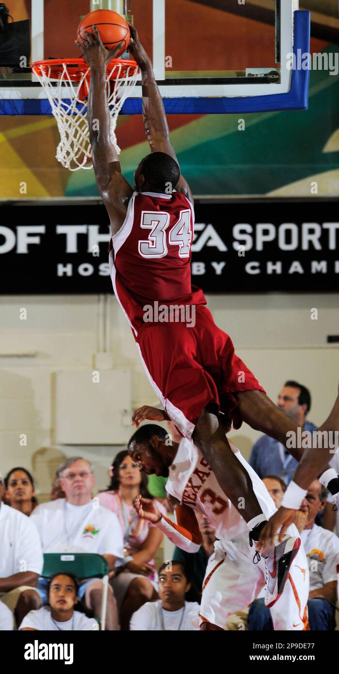 Saint Joseph's Ahmad Nivins dunks over Texas' A.J. Abrams during the