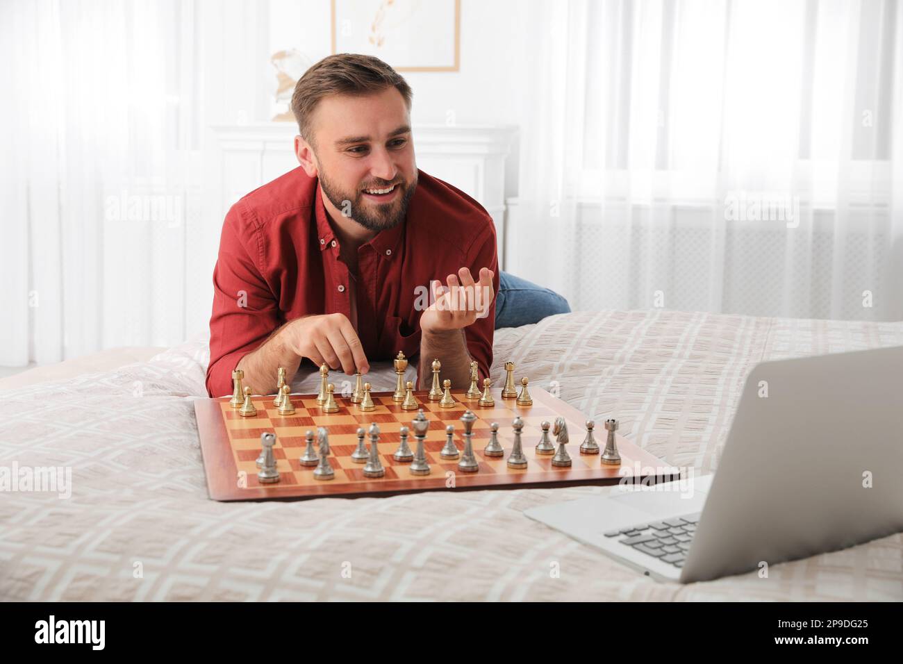 Caucasian man playing chess computer hi-res stock photography and