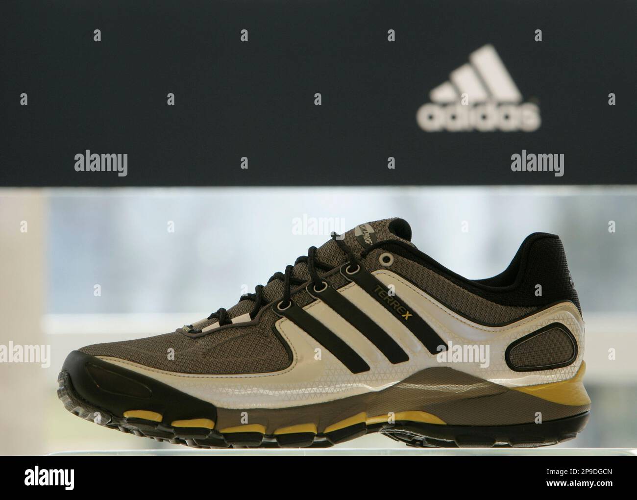 FILE**In this March 5, 2008 file photo a sneaker is displayed in front of  the company's logo of the Adidas Group in Herzogenaurach, southern Germany.  Sportswear company Adidas AG has signed an