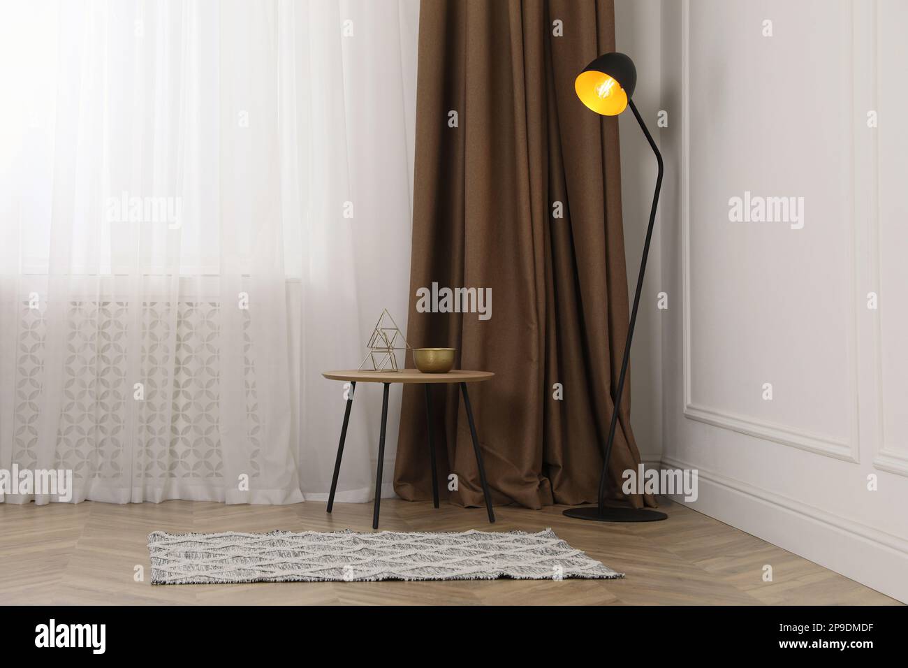 Modern living room interior with table and floor lamp Stock Photo - Alamy