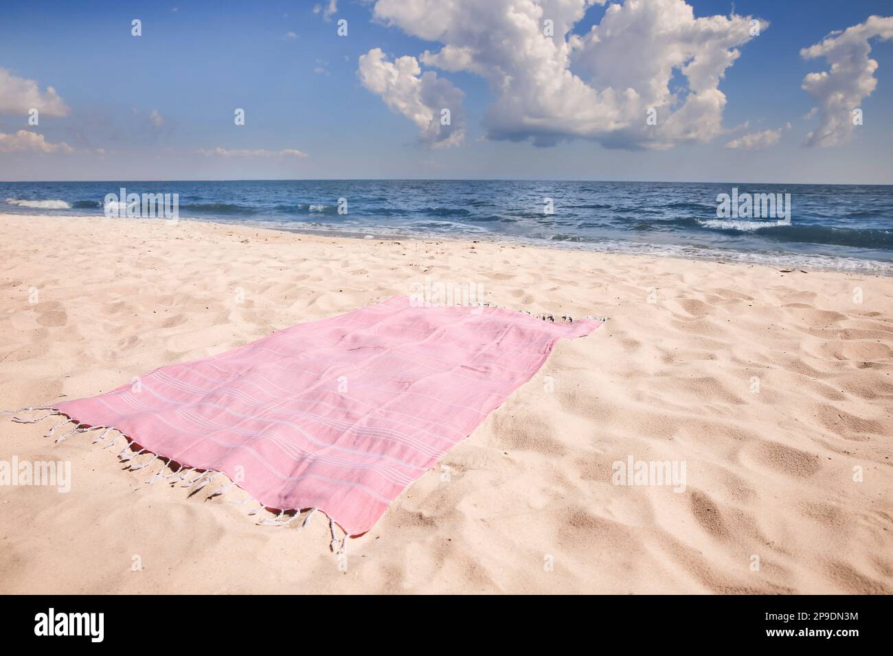 Pink striped beach towel on sandy seashore Stock Photo - Alamy