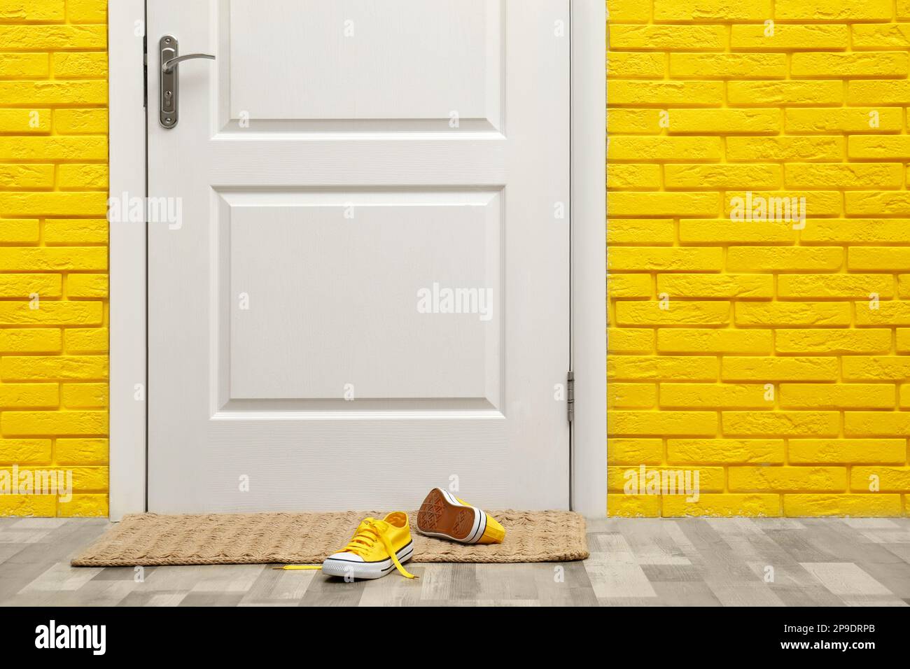 Stylish shoes on door mat in hallway Stock Photo Alamy