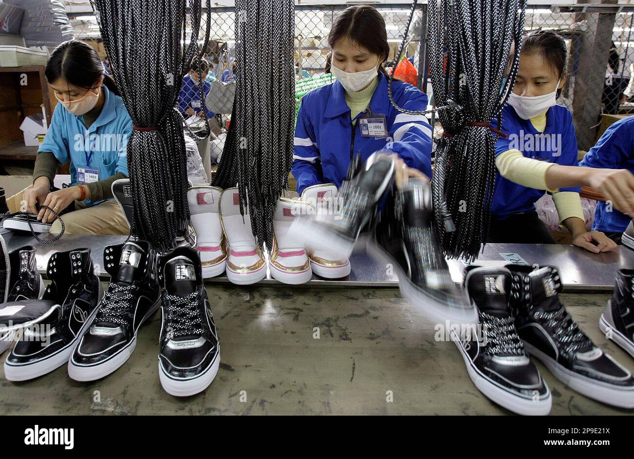 Workers work on assembly line of shoes at Thuong Dinh Shoe factory in  Hanoi, Vietnam, Thursday, Nov. 20, 2008. Thuong Dinh Shoe factory produces  shoes for domestic markets and for exports. The