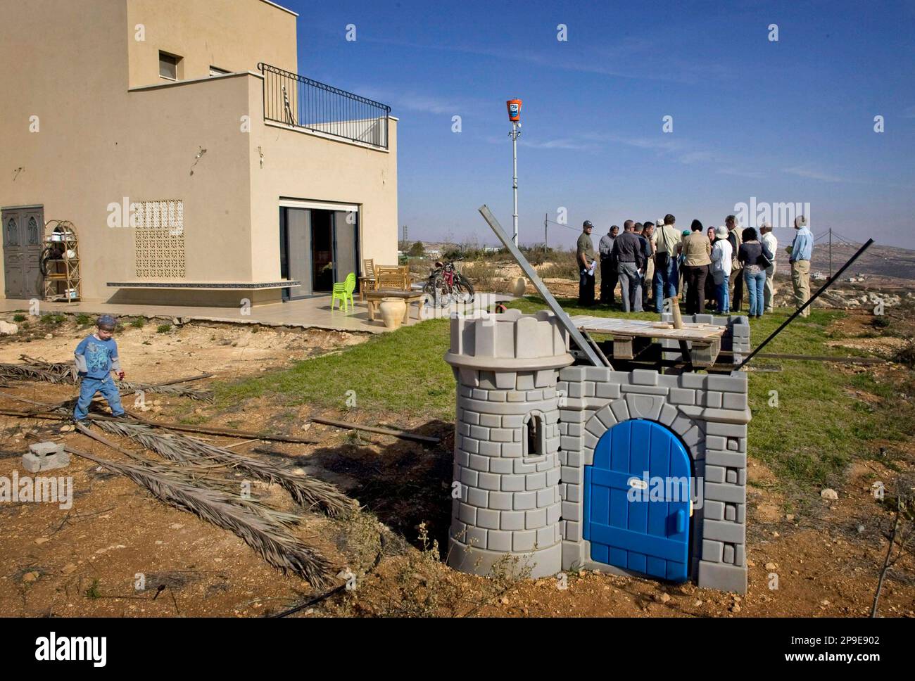 foreign journalists who participated in a tour organized by a jewish settler group gather outside eliana passentins house in the west bank jewish settlement of eli monday nov 17 2008 the settlers said they were trying to show the world theyre regular folks trying to live peaceful lives but the bus bulletproof windows the ubiquitous barbed wire and the watch towers keeping guard over the settlers homes betrayed an existence that is anything but normal ap photosebastian scheiner 2P9E902