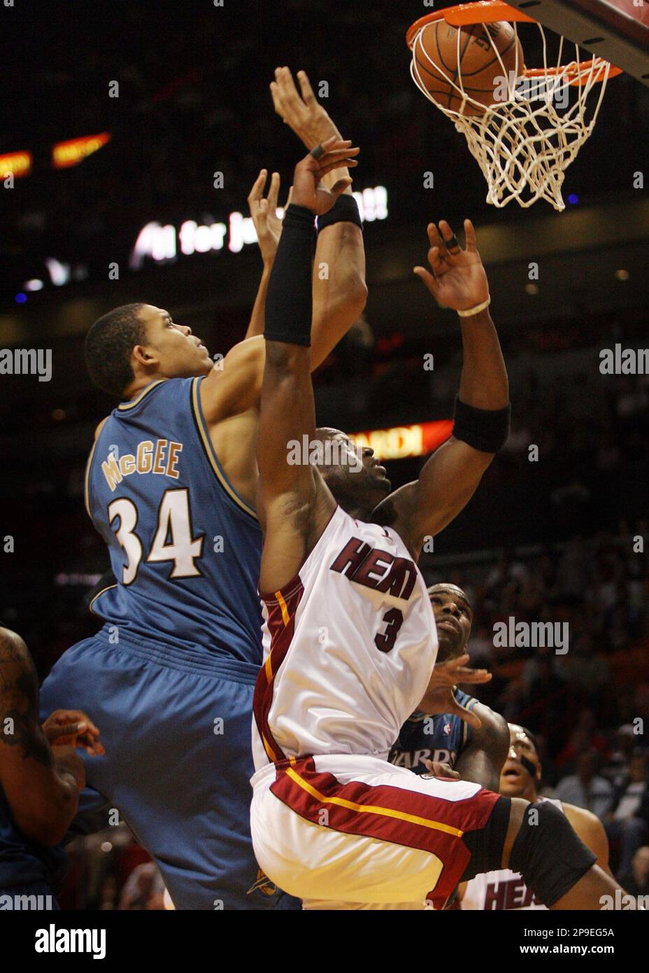 Miami Heat's Dwyane Wade scores as Washington Wizards' JaVale McGee ...