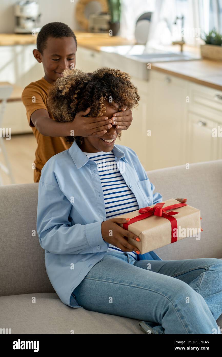 Excited happy African American woman mother receiving mothers day gift ...