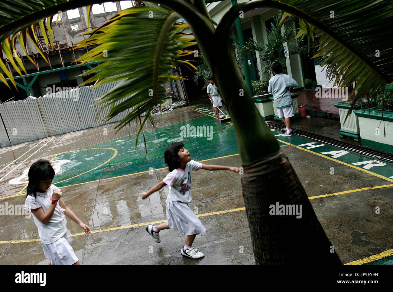 ** FILE ** In this Jan. 23, 2007 file photo, Indonesian school girls run on the playground at the SDN Menteng 1 school in Jakarta, Indonesia. President-elect Barack Obama attended the school when he was a child. Places that U.S. presidents have called home often become major tourist attractions, from estates at Mount Vernon and Monticello, to Hodgenville, Ky., where Abe Lincoln's log cabin once stood. But if you want to see all the places connected to Obama's life story, you'd need to visit three countries, five time zones and six states. (AP Photo/Ed Wray, File) Stock Photo