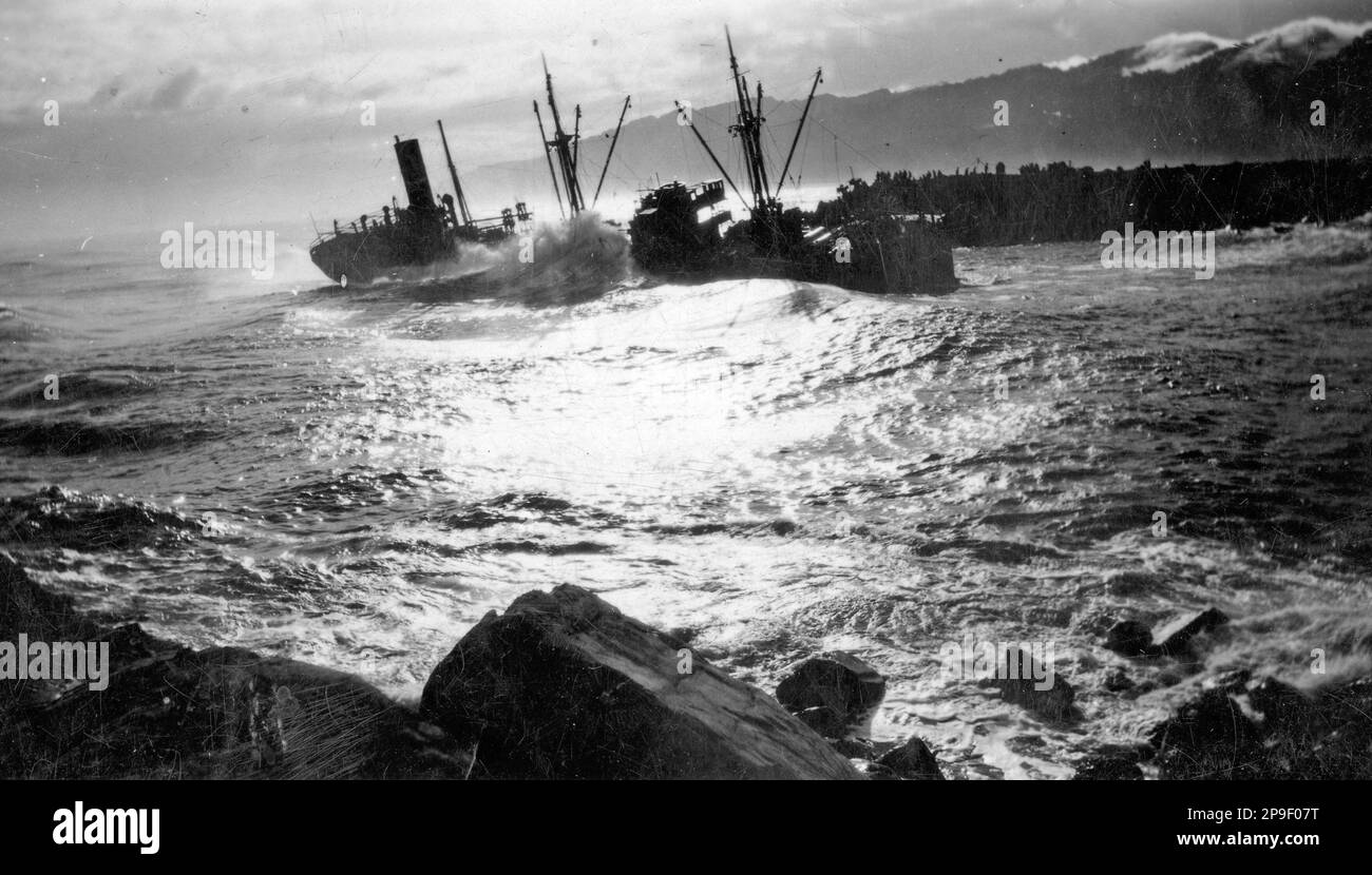 Waves breaking up the Kaponga, which was stranded on the bar while leaving Greymouth, Westland, New Zealand, on 27.5.1932, and eventually became a total wreck on the north tiphead. The steel screw steamship weighed 2346 tons gross and had a net register of 1167 tons. Stock Photo