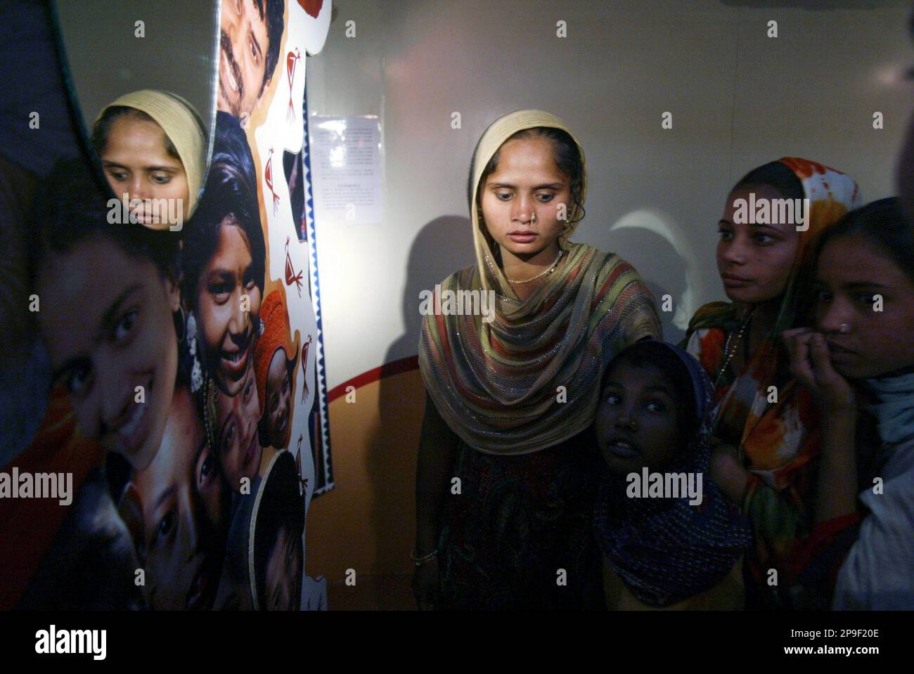 Red Ribbon Express Women from shanty towns look at HIV/AIDS awareness posters inside Red ...