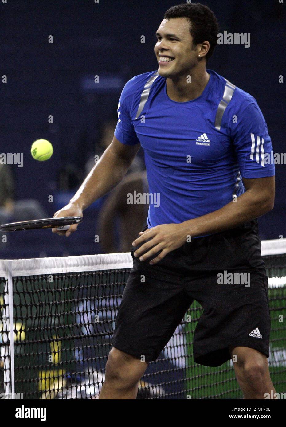 French tennis player Jo-Wilfried Tsonga smiles after failing to return a  shot to Briton Andy Murray during practice for the upcoming Tennis Masters  Cup in Shanghai, China Friday Nov.7, 2008. (AP Photo/Bullit