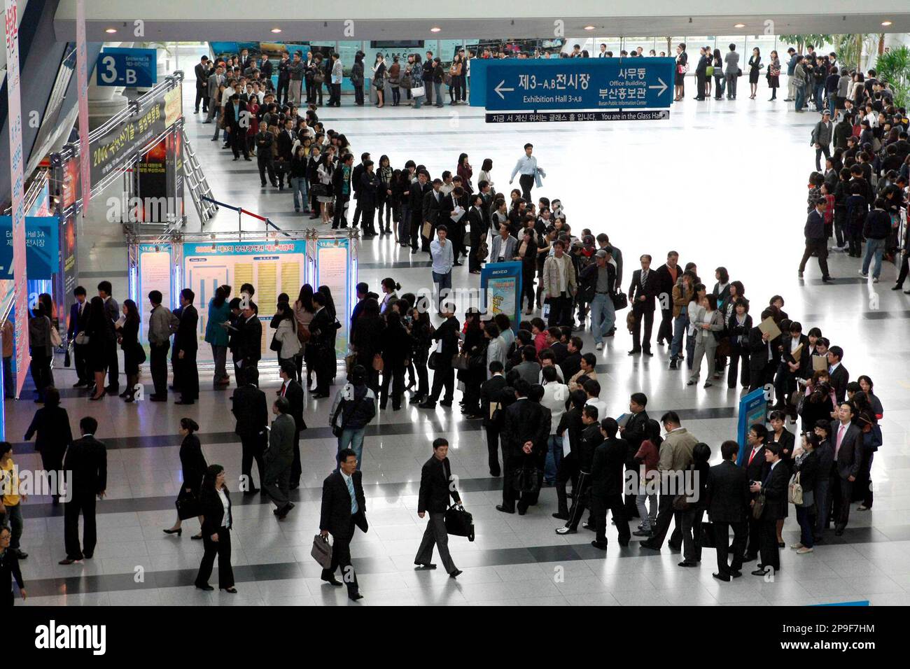 South Korean jobseekers line up to apply for jobs during an job fair