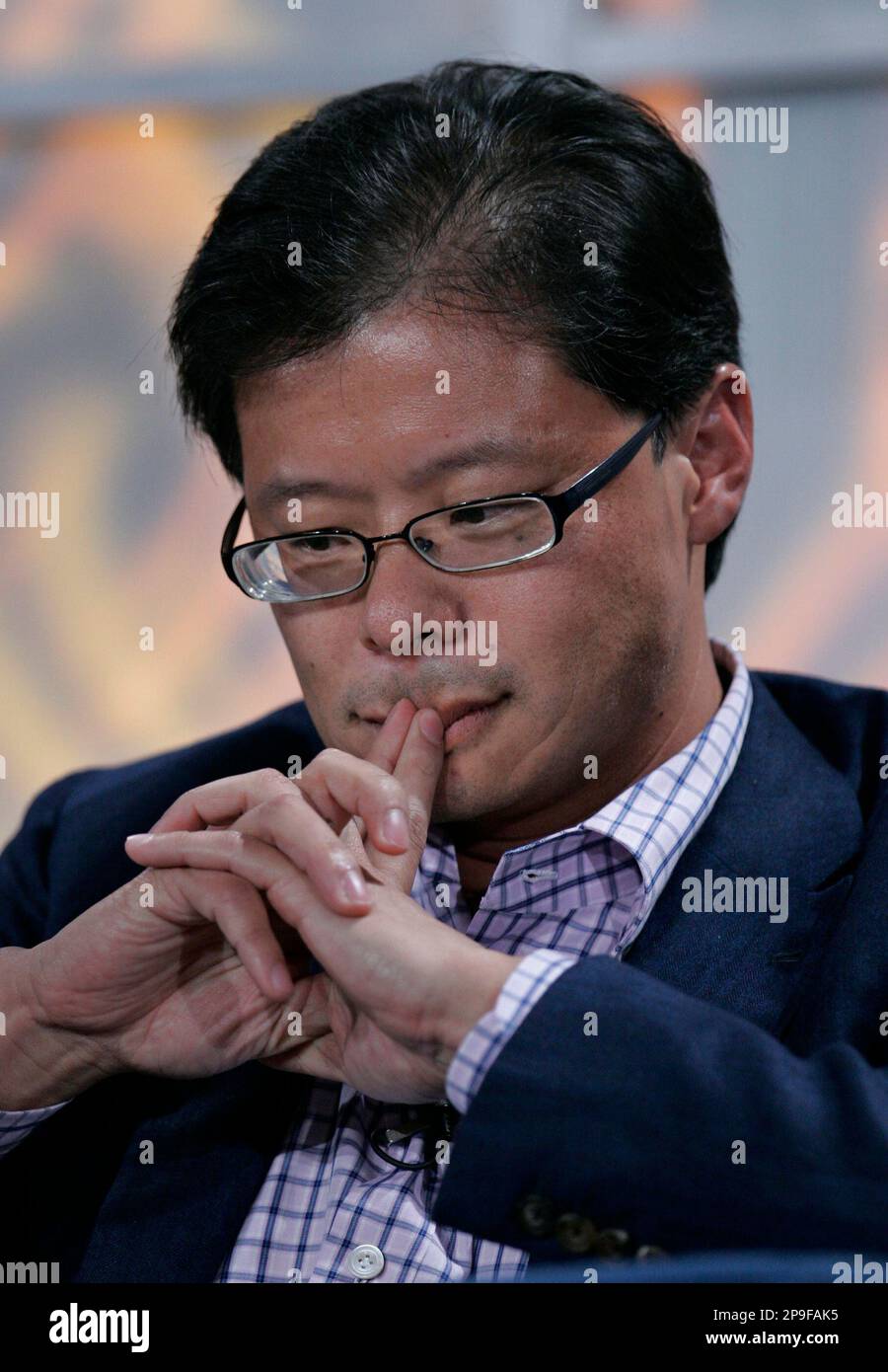 Yahoo CEO Jerry Yang ponders a question during a talk at the Web 2.0 Summit in San Francisco, Wednesday, Nov. 5, 2008. Facing a legal battle that would have illuminated its widening market power, Google Inc. turned its back on its struggling rival Yahoo Inc. and pulled the plug on an Internet advertising partnership that had been conceived to keep Yahoo out of Microsoft Corp.'s clutches. (AP Photo/Paul Sakuma) Stock Photo
