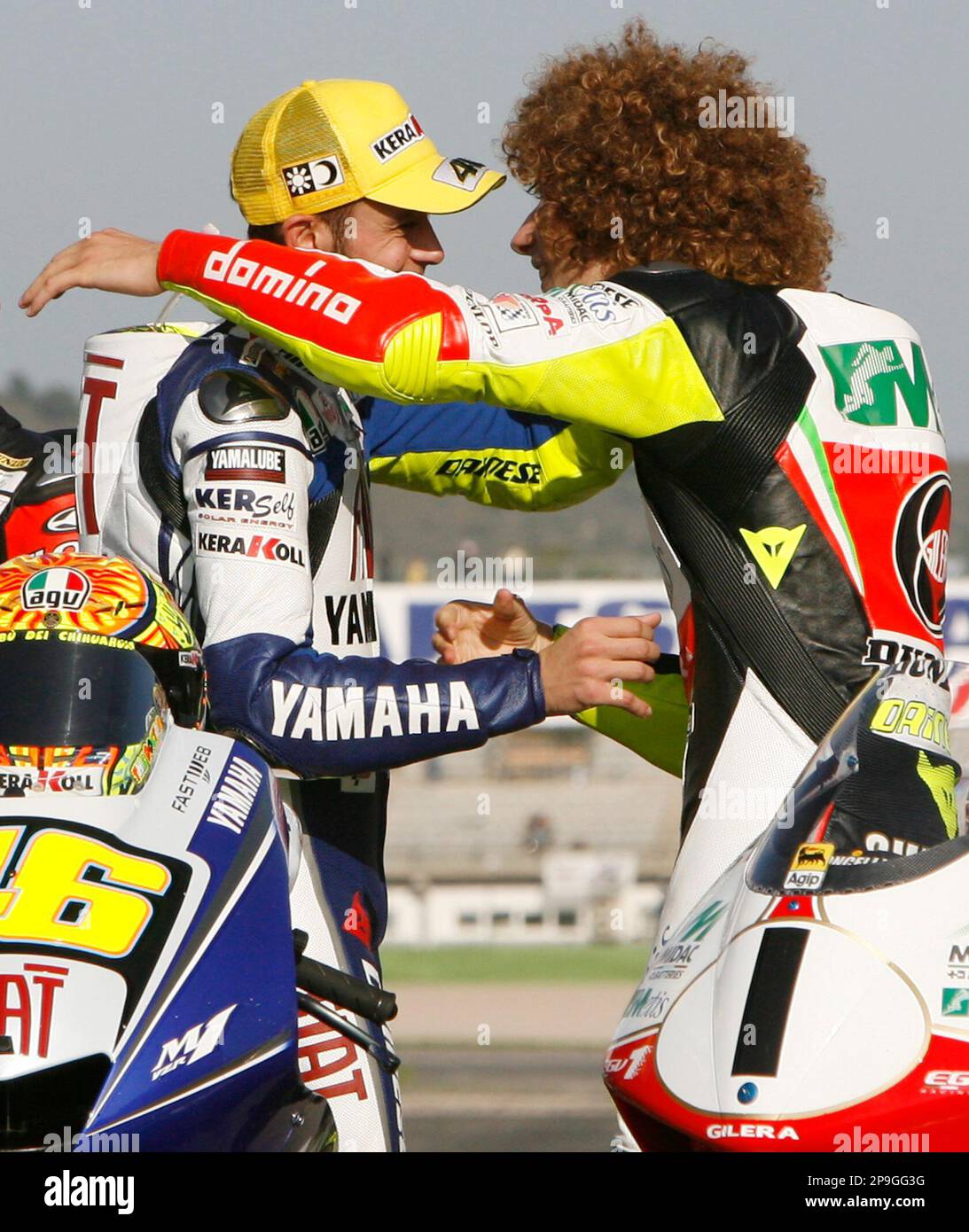 Moto GP World Champion Valentino Rossi of Italy, left, and the World 250cc Marco Simoncelli of Italy, embrace the Valencia Motorcycle Grand Prix, the last race of the season,