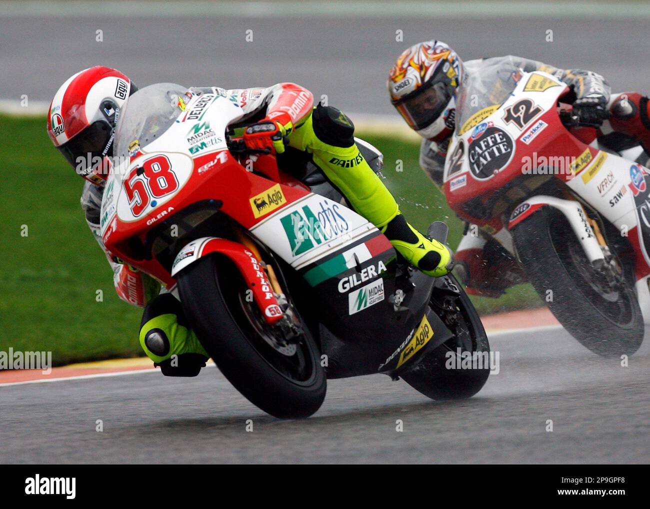 250cc 2008 World Champion Marco Simoncelli of Italy, left takes a curve on  his Gilera followed by Thomas Luthi of Switzerland on his Aprilia during  practice for Sunday's Valencia Motocycle Grand Prix,