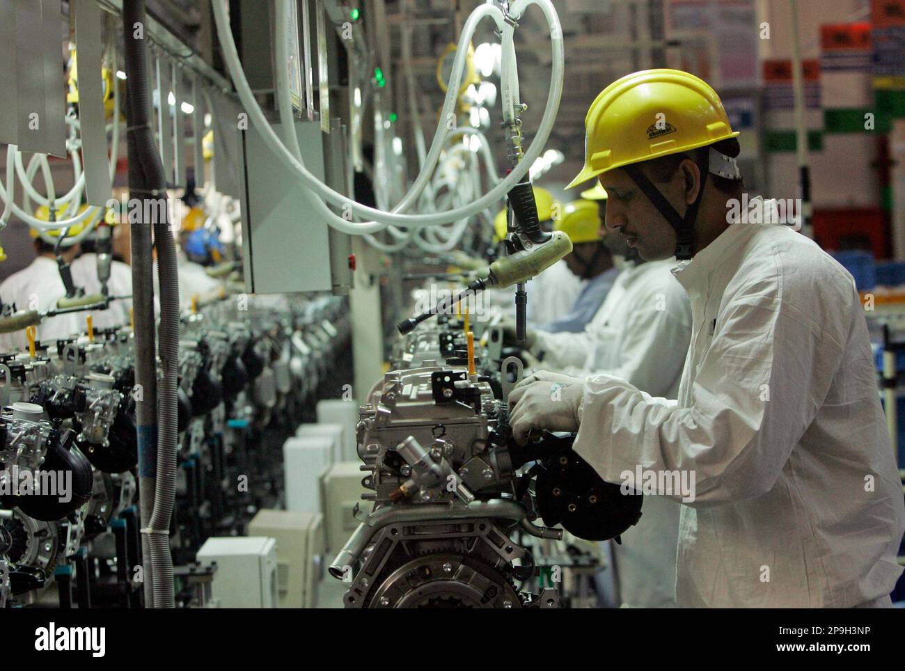 Operator Assembly Engine A worker assembles a semi complete engine at the assembly line of the ...