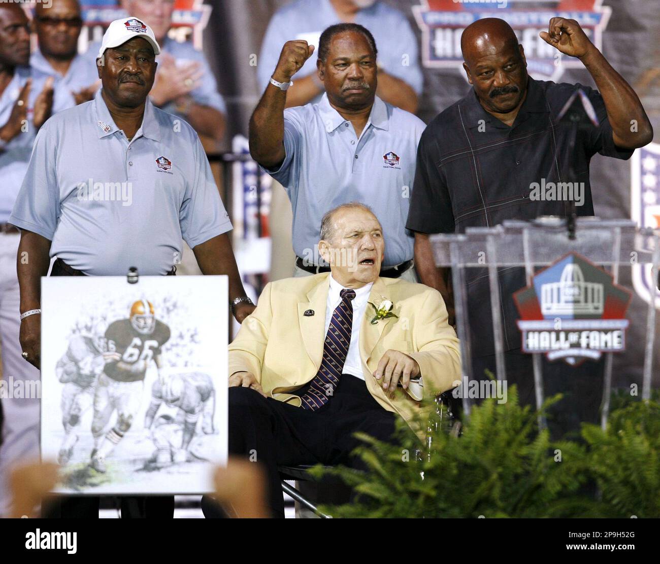 FILE**Cleveland Browns Hall of Fame running backs (from left) Leroy Kelly,  Bobby Mitchell and Jim Brown brought Gene Hickerson (front) onto the stage  during Hickerson's enshrinement into the Pro Football Hall of