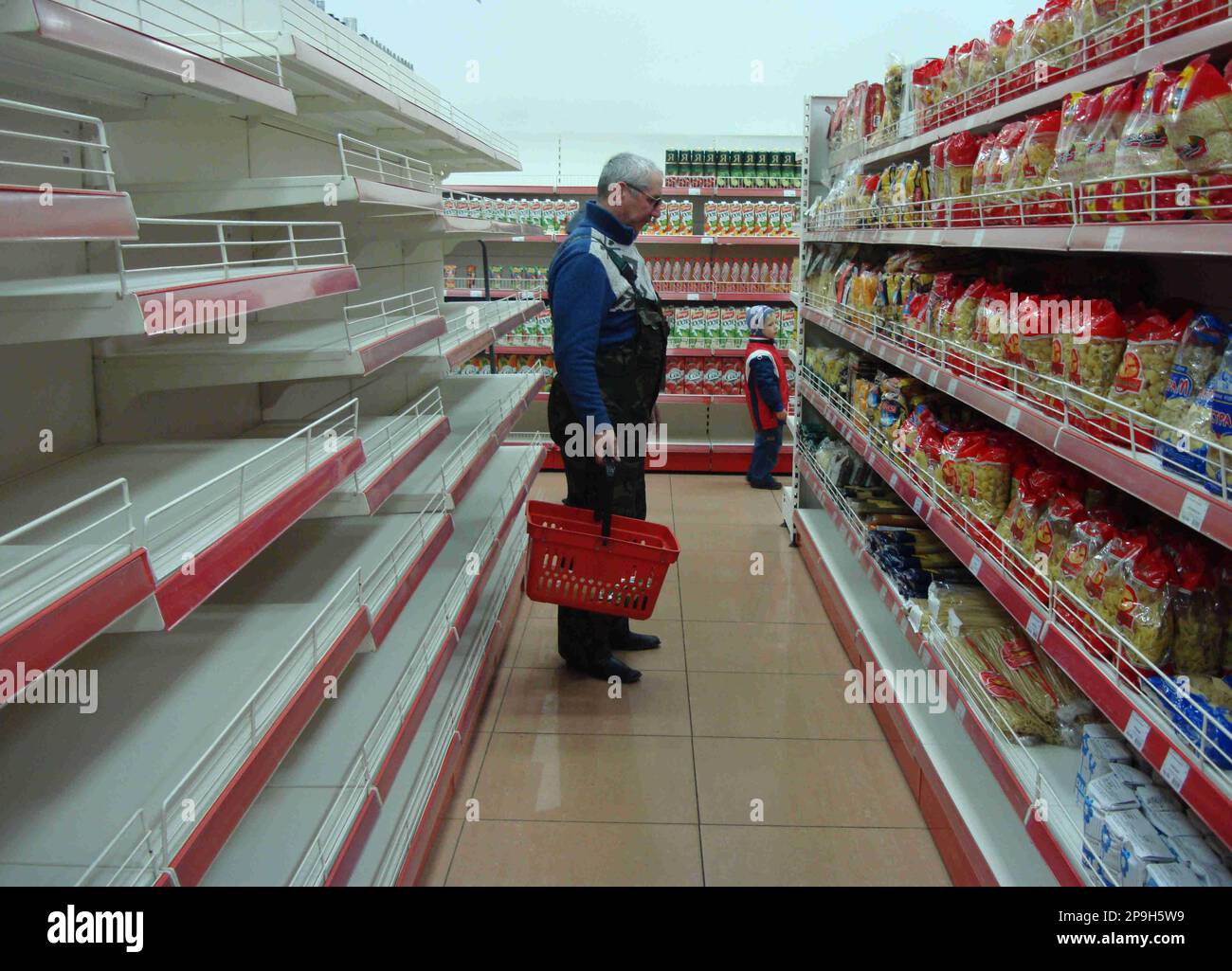 A man shopping at a local supermarket Moscow, Monday, Oct. 20, 2008. Some analysts say that Russia's economy remains relatively healthy and the currency should show more resilience, but many Russians still remember the 1998 currency collapse. (AP Photo/Misha Japaridze) Stock Photo
