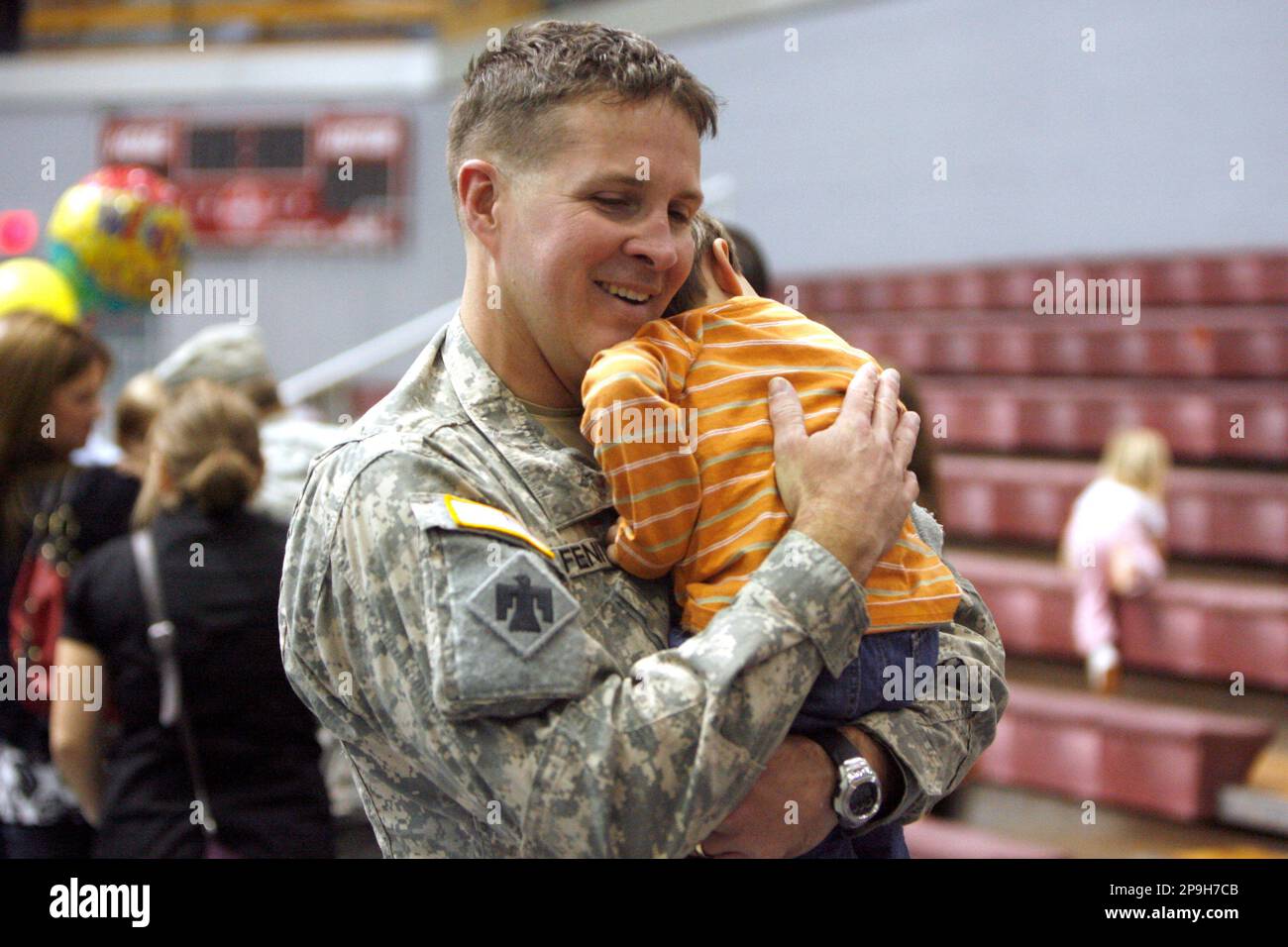 Sgt. 1st Class Rohn Fenity, of Oklahoma City, hugs his son, Logan, 1 ...
