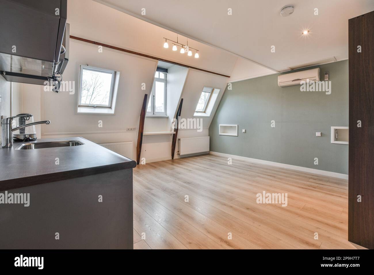 a room with wood flooring and an air condition heater on the wall in ...