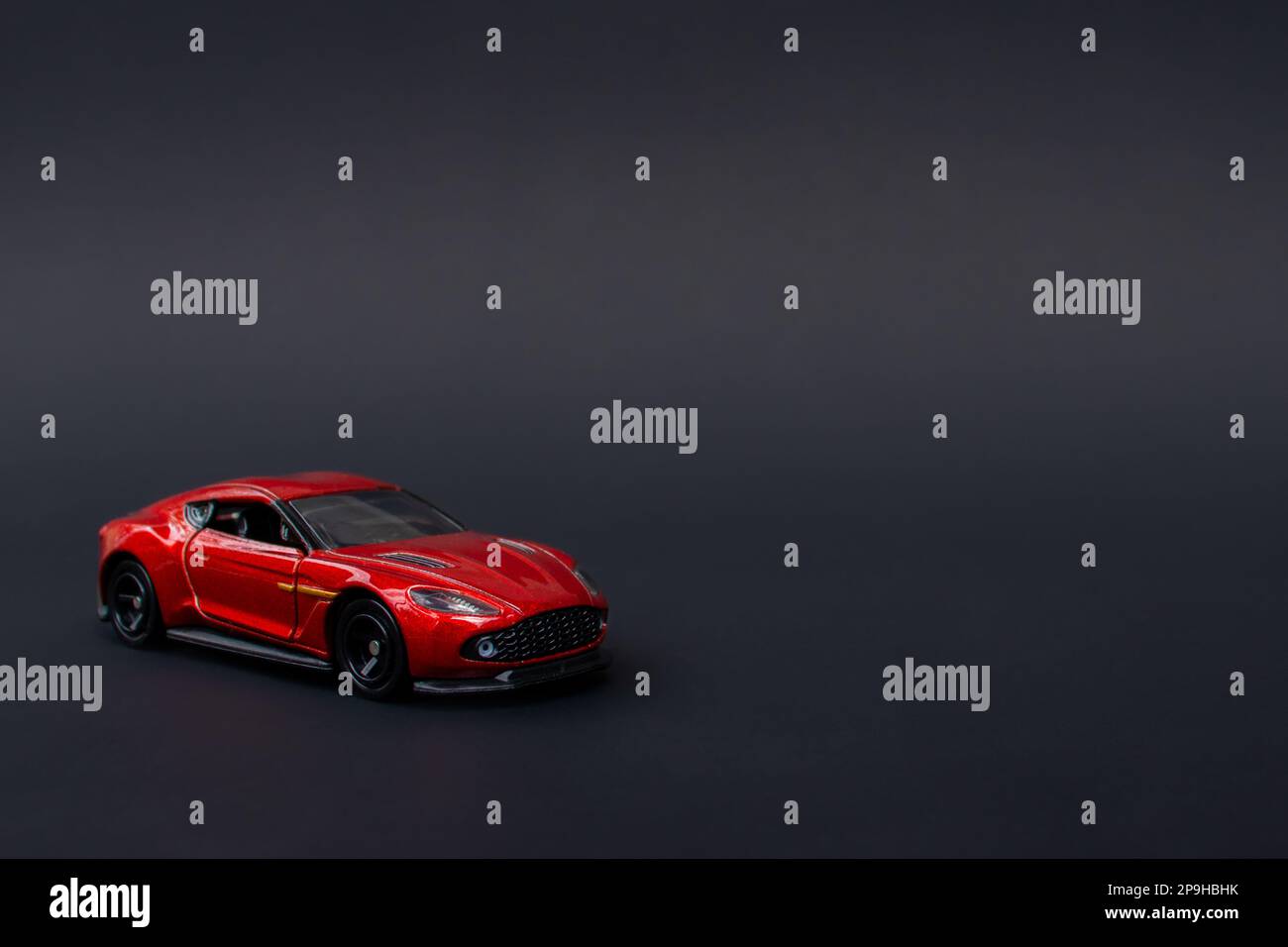 A photo of a red toy car on isolated black background, after some edits ...
