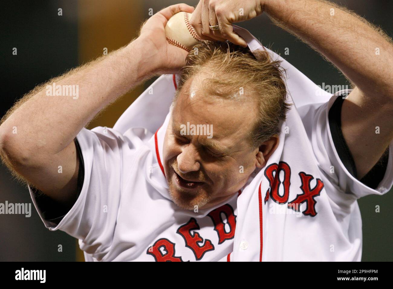 Boston Red Sox pitcher Curt Schilling takes off his jersey after