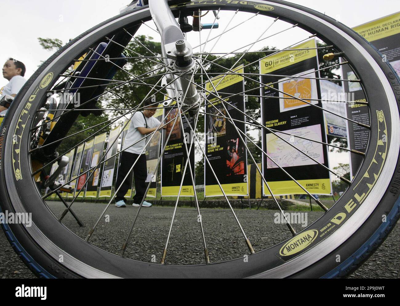 A Filipino man arranges posters containing basic human rights ...
