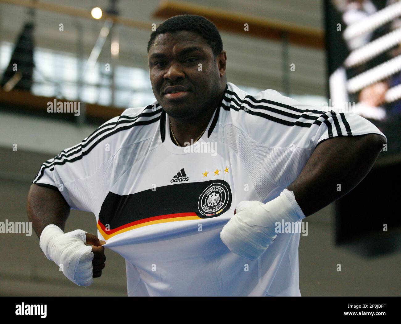 Boxer Samuel Peter from Nigeria adjusts his shirt during a public