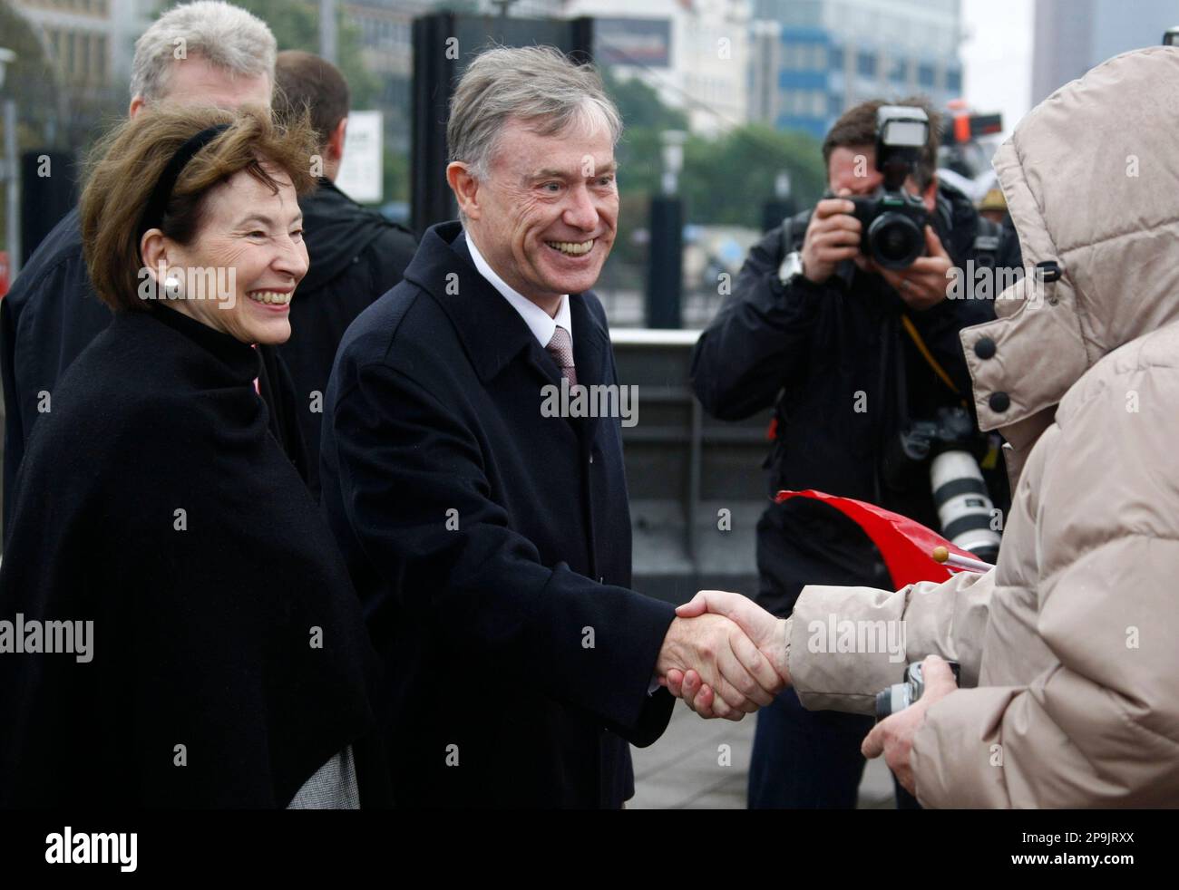 German President Horst Koehler and his wife Eva Luise cheer passersby ...