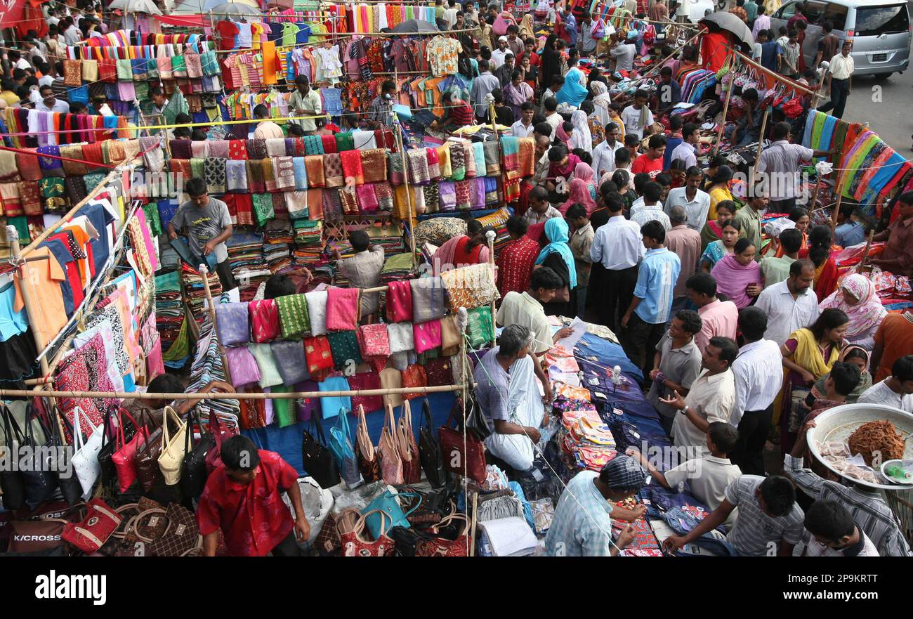 Bangladeshi people shop for the Eid-al-Fitr festival at a street market