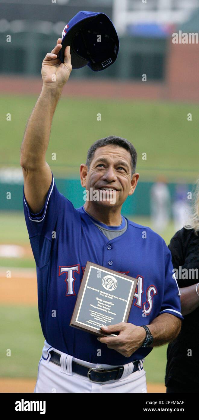 Texas Rangers hitting coach Rudy Jaramillo tips his hat to the