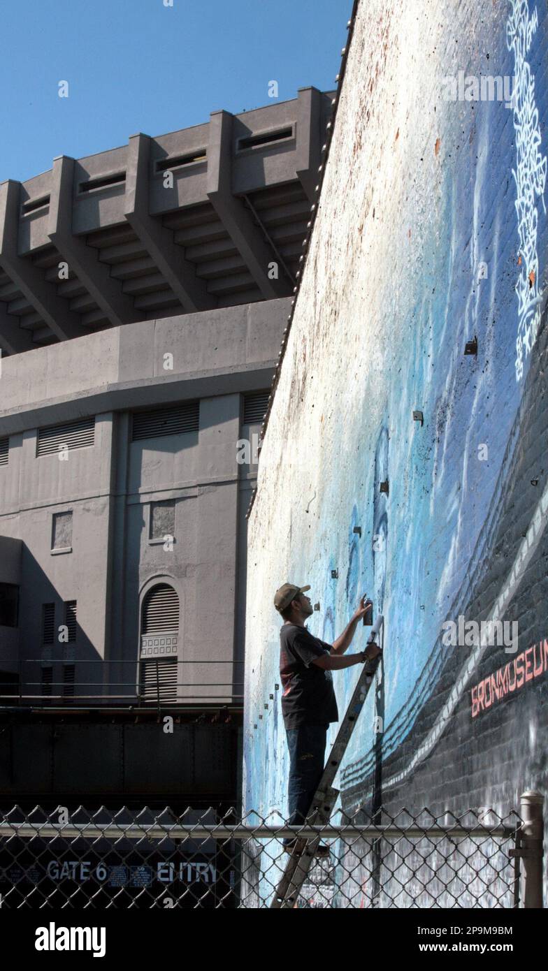 Artist Alfred "King B" spray paints a likeness of Yankees great