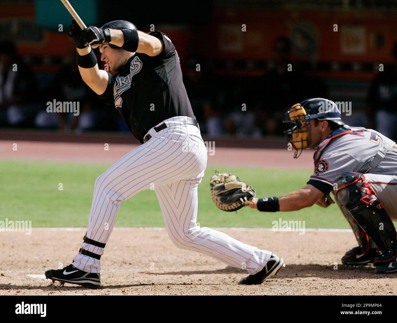Florida Marlins' Josh Willingham follows through on his base hit ...