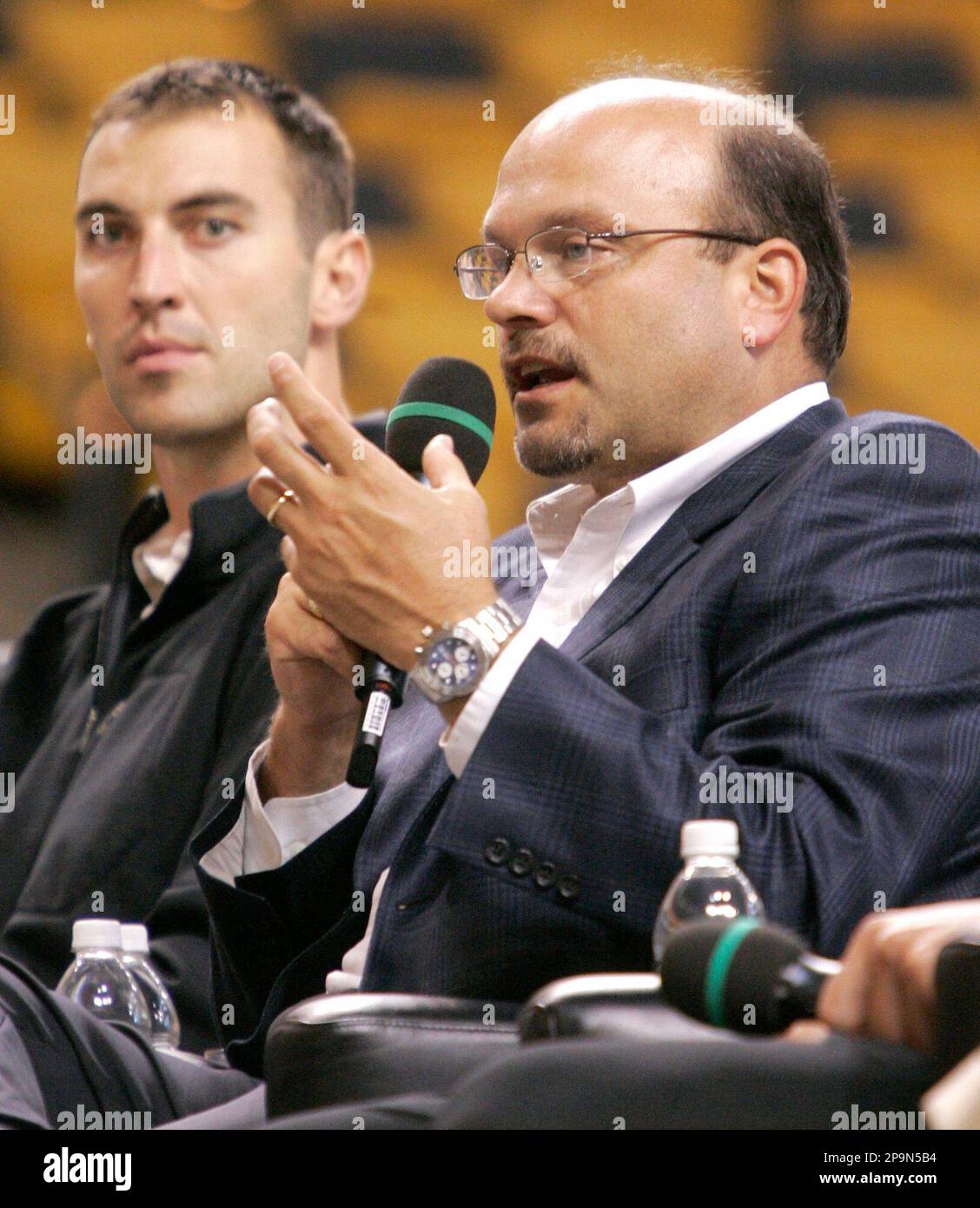 Boston Bruins general manager Peter Chiarelli, right, addresses an