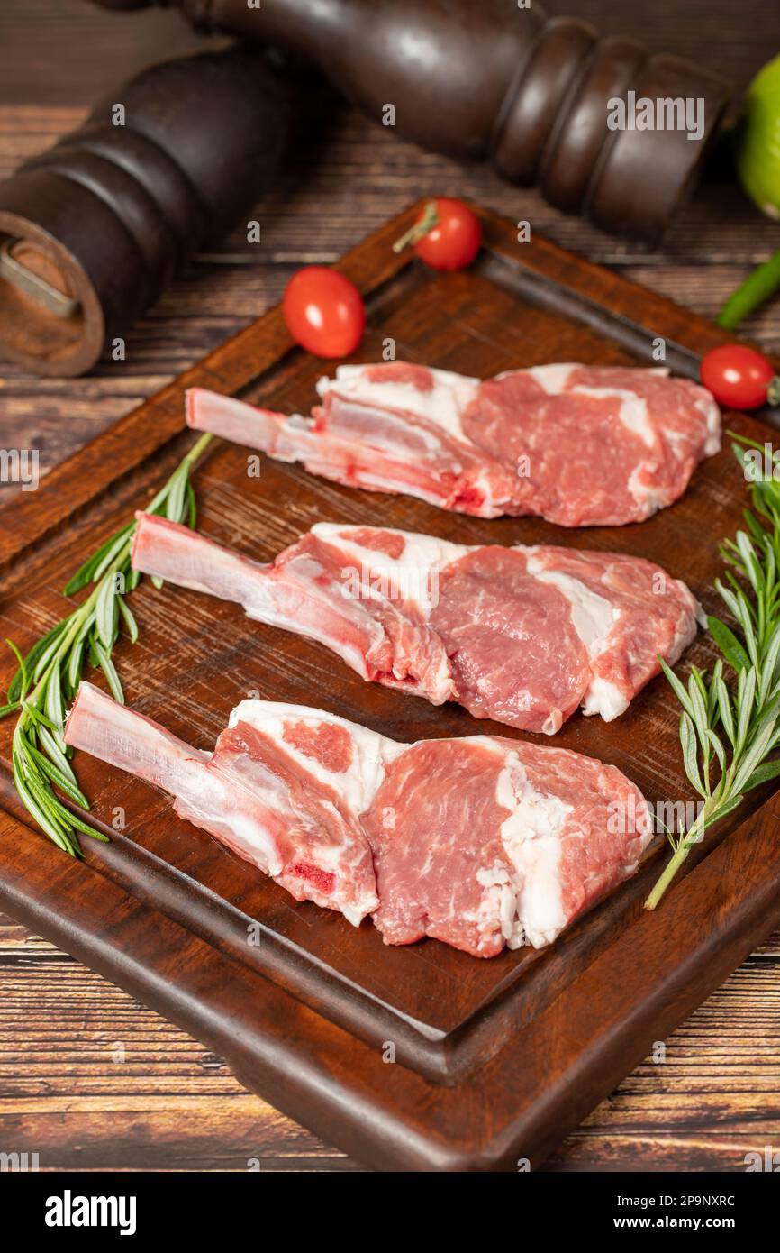 Raw lamb chops. Fresh raw lamb chops with spices and herbs. Wood