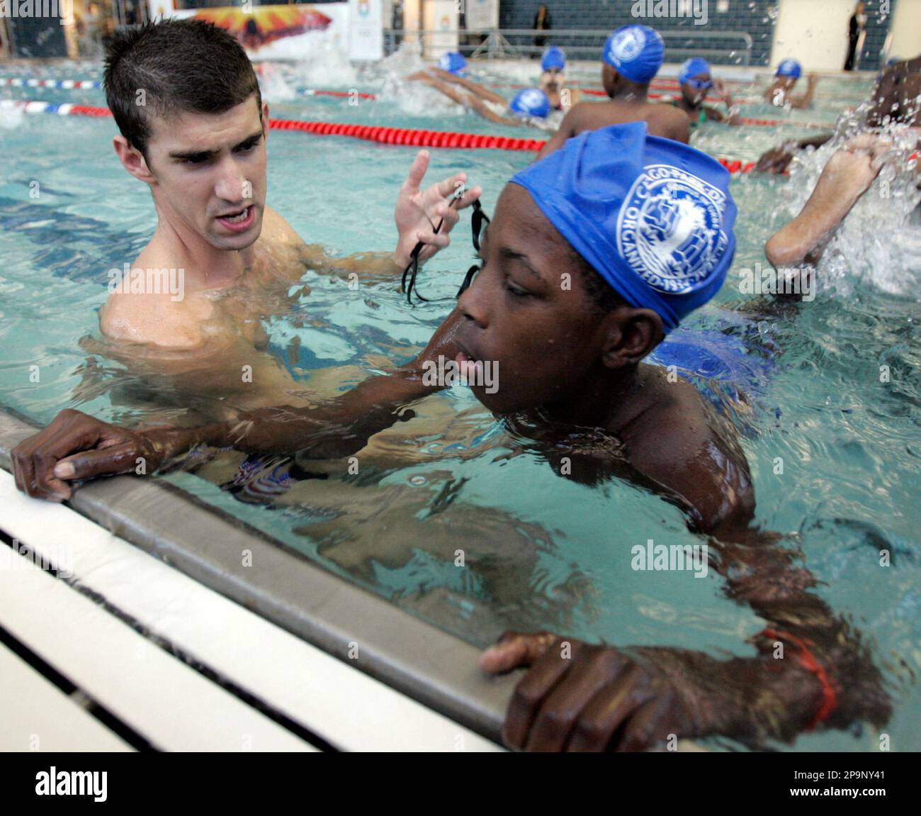 Olympic gold medalist Michael Phelps, left, explains his technique to ...