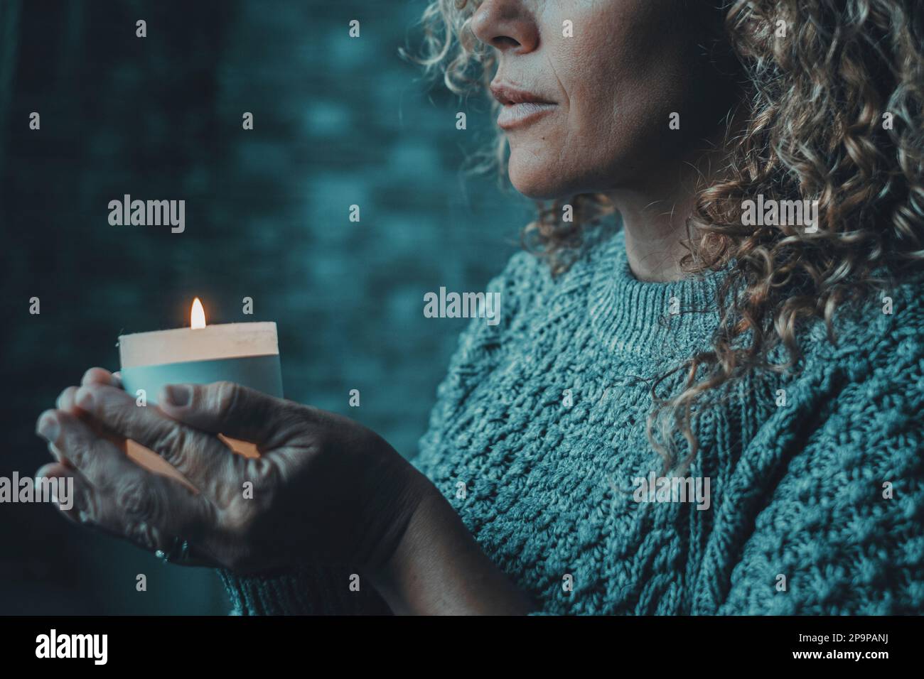 One woman indoor at home, lights candles, enjoy meditation, do yoga