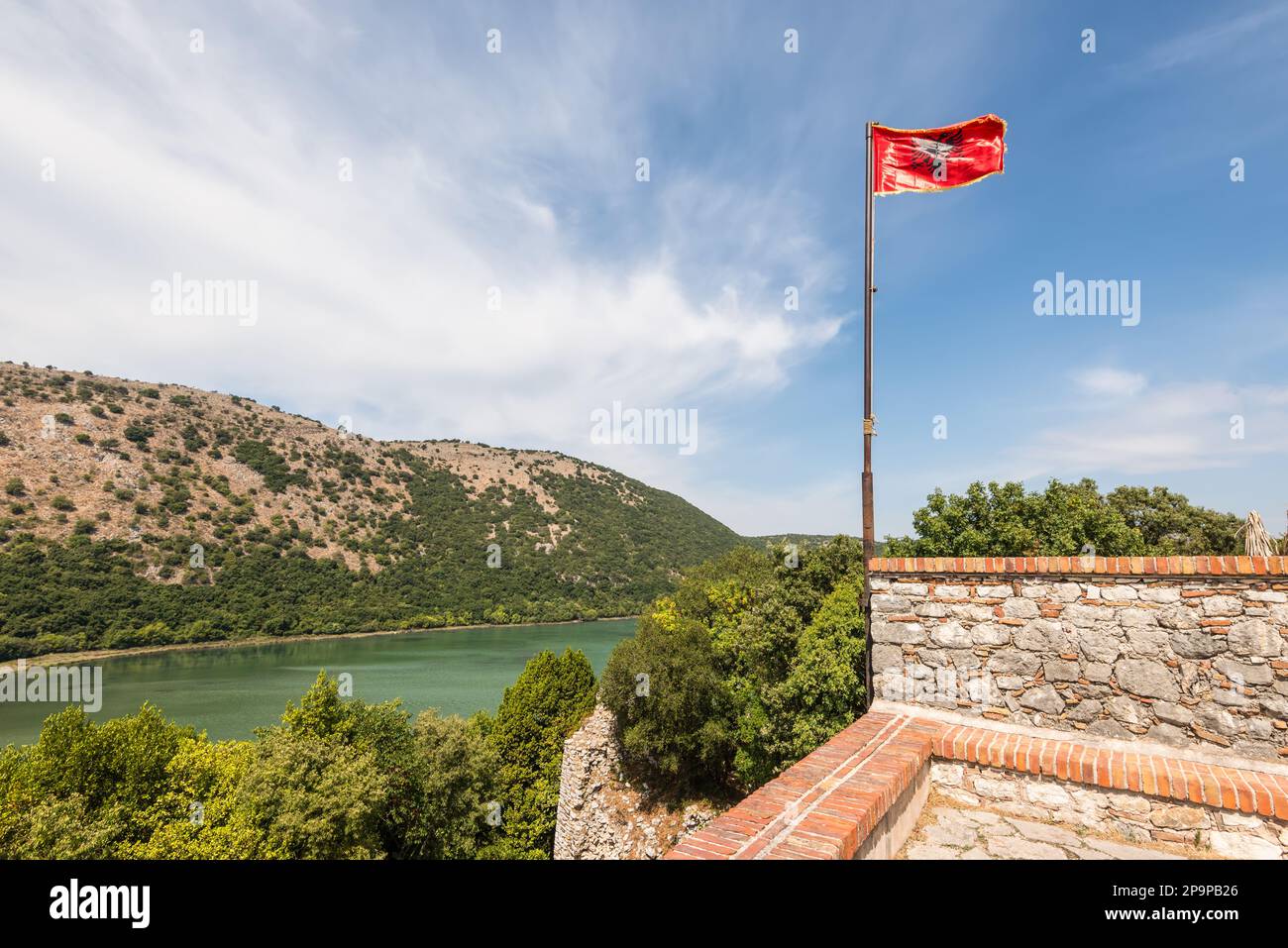 Beautiful landscape with Albanian flag and archeological ruins at ...