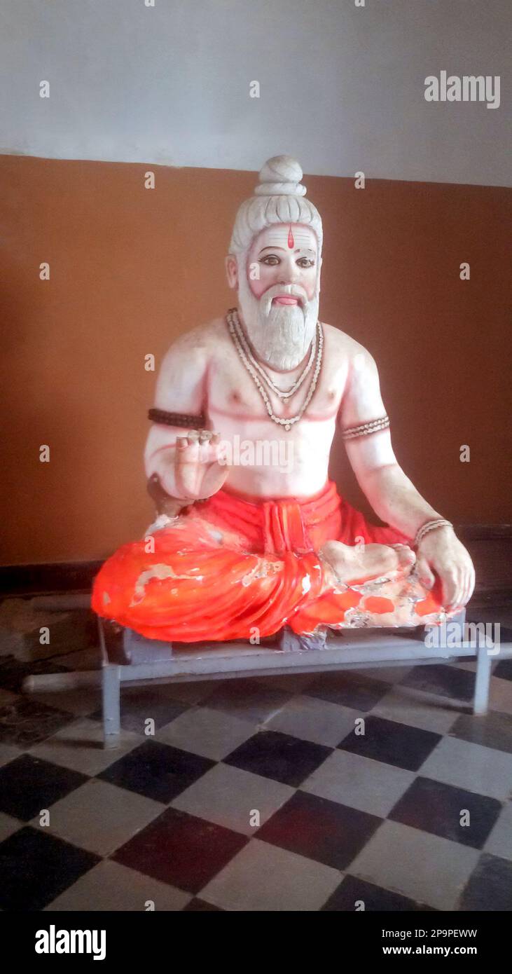 Old statue and worn out statue of a Rishi muni in India Stock Photo