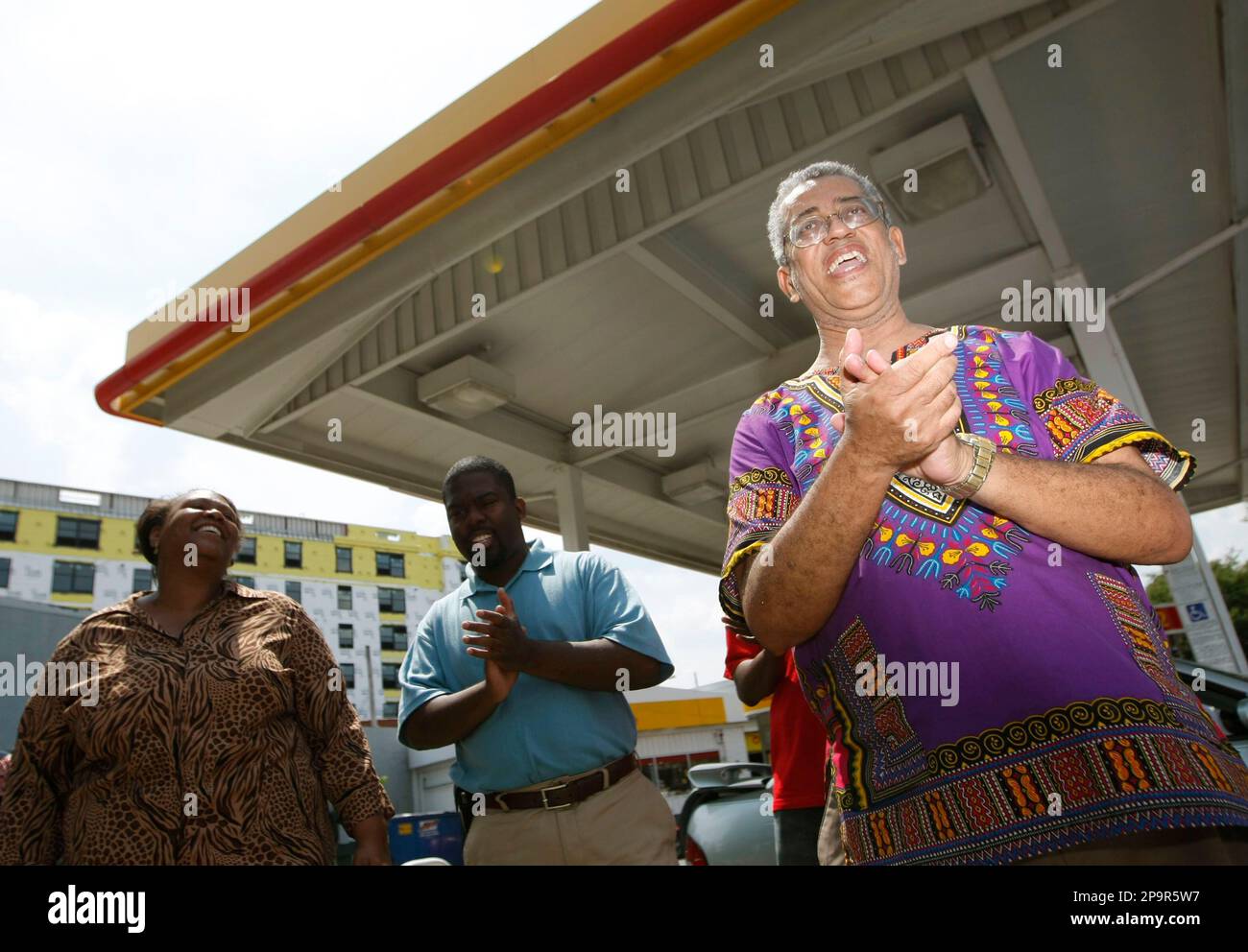 Pray at the Pump movement founder Rocky Twyman, right, at a local Shell Gas  Station, Wednesday, Aug. 13, 2008, in Washington. Also with Twyman are  Jocelyn McClure, left, and Pastor Gamal Alexander,