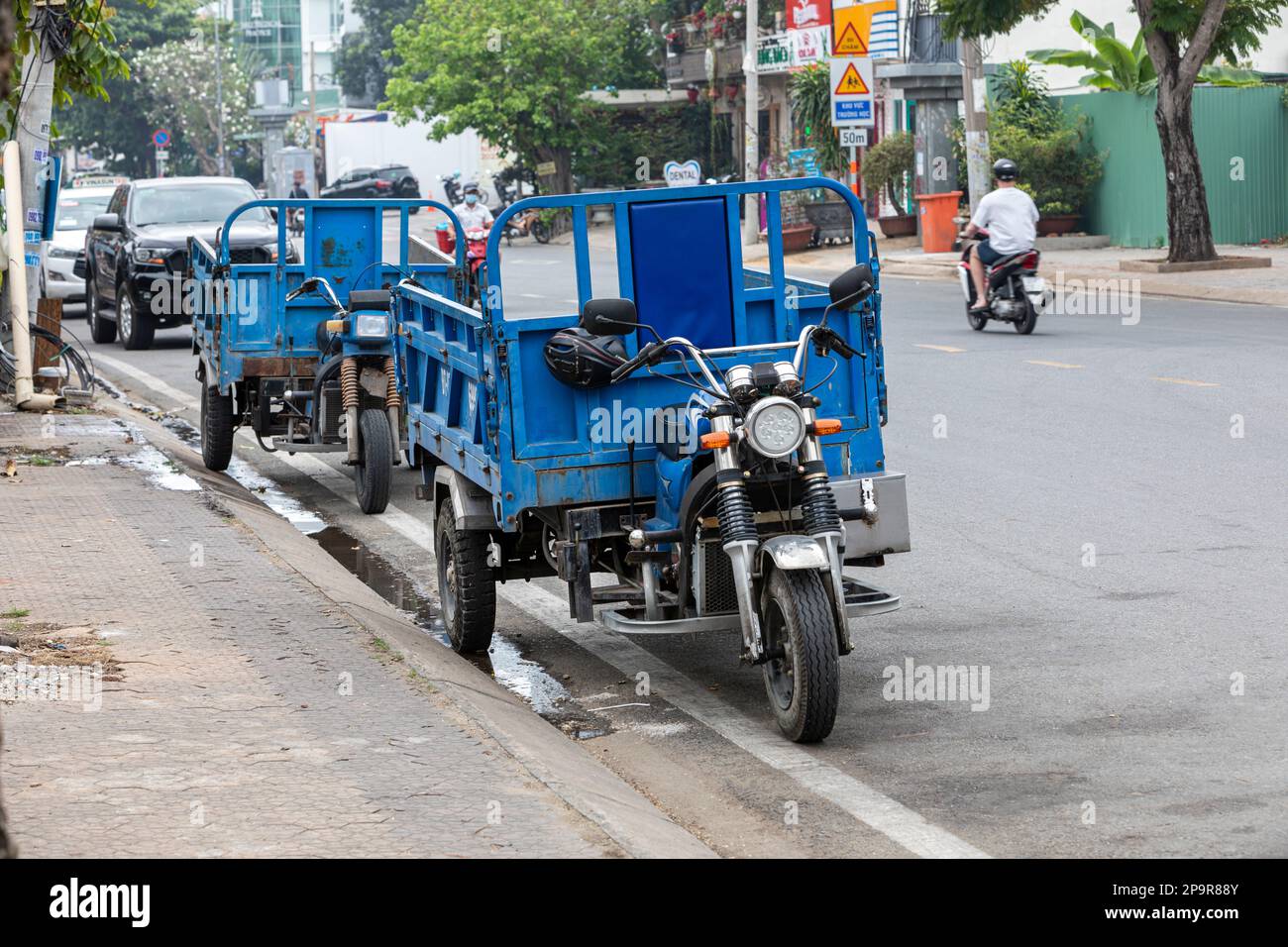 Two three wheeled motor bike cargo carriers in Ho Chi Minh City