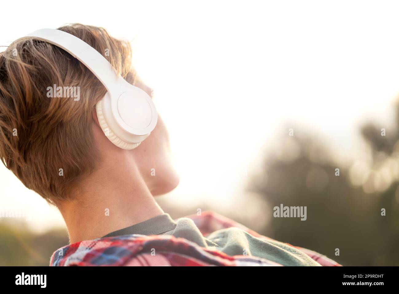Young urban woman with short hair in big headphones close-up. Stock Photo