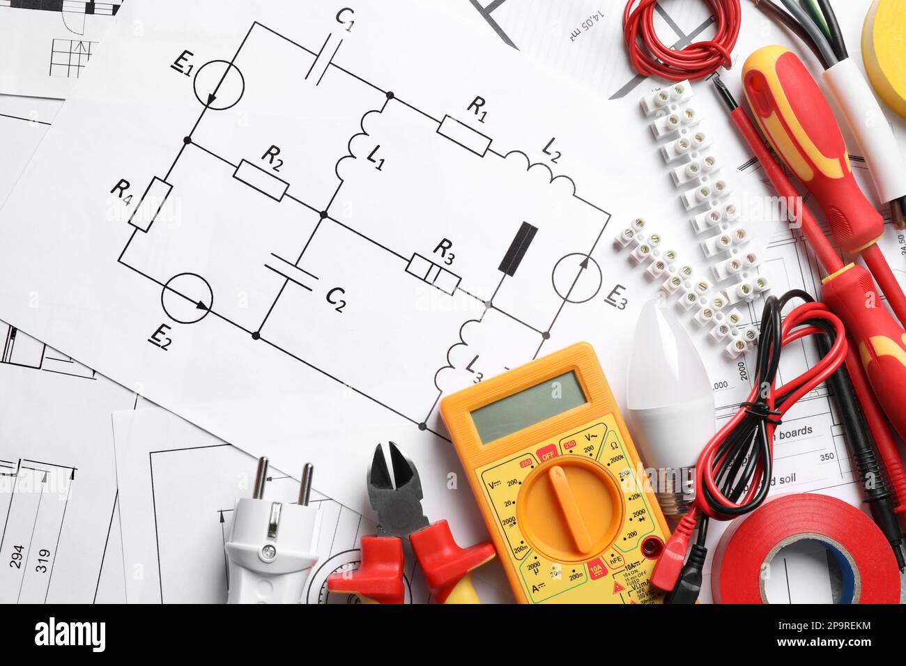 Set of electrician's tools and accessories on paper sheets with scheme