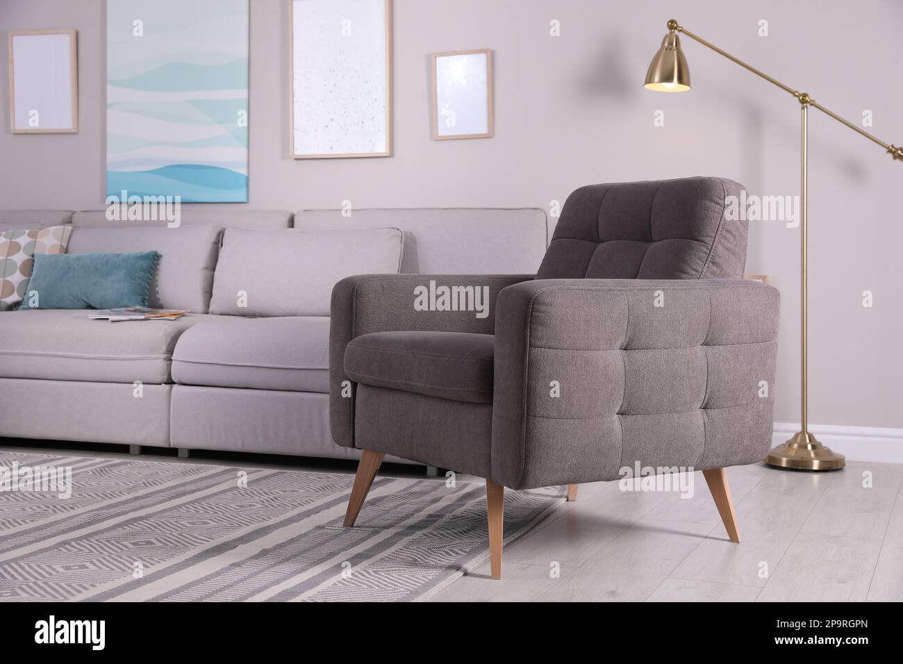 Stylish living room interior with comfortable armchair and sofa Stock