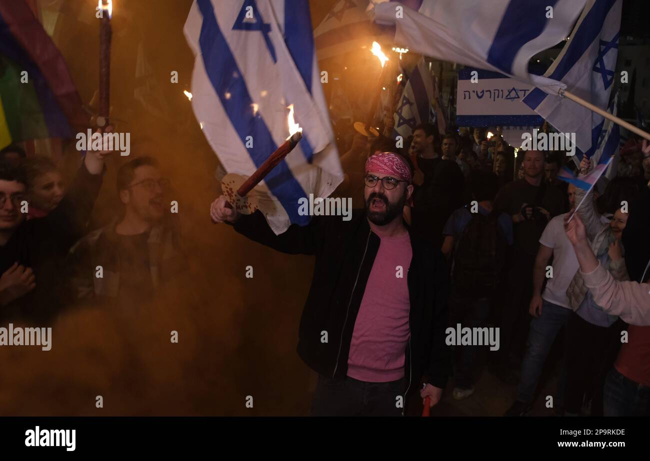 TEL AVIV, ISRAEL - MARCH 9: Anti-Government protesters hold flaming torches and set off smoke bombs during a demonstration against Israel's hard-right government judicial system plan that aims to weaken the country's Supreme Court on March 9, 2023 in Tel Aviv, Israel. Stock Photo