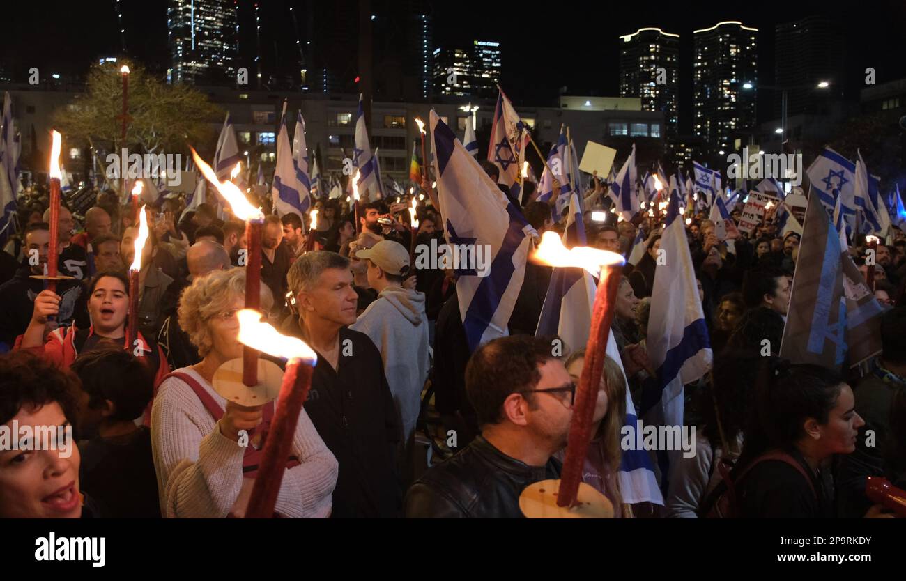 TEL AVIV, ISRAEL - MARCH 9: Anti-Government protesters hold flaming torches during a mass demonstration against Israel's hard-right government judicial system plan that aims to weaken the country's Supreme Court on March 9, 2023 in Tel Aviv, Israel. Stock Photo