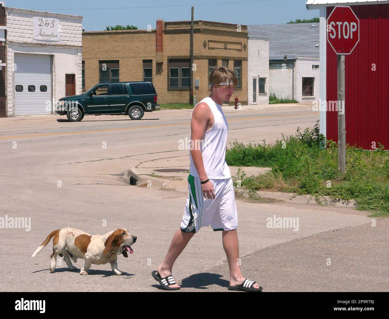 Charles Schuett, 17, and his basset hound Jake walk in downtown Maxwell