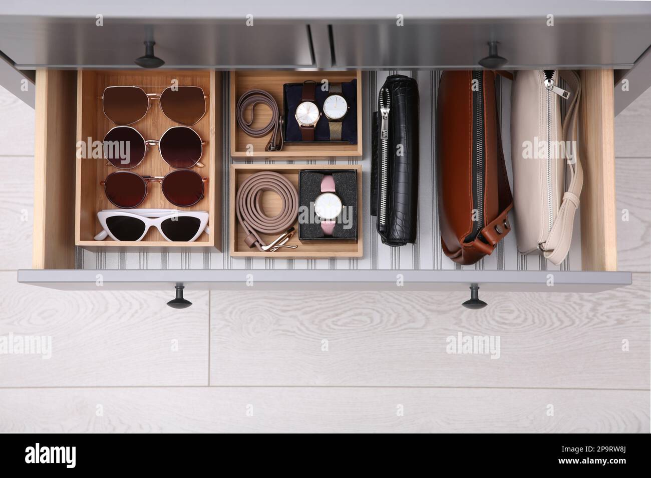 Open drawer with different stylish accessories indoors, top view