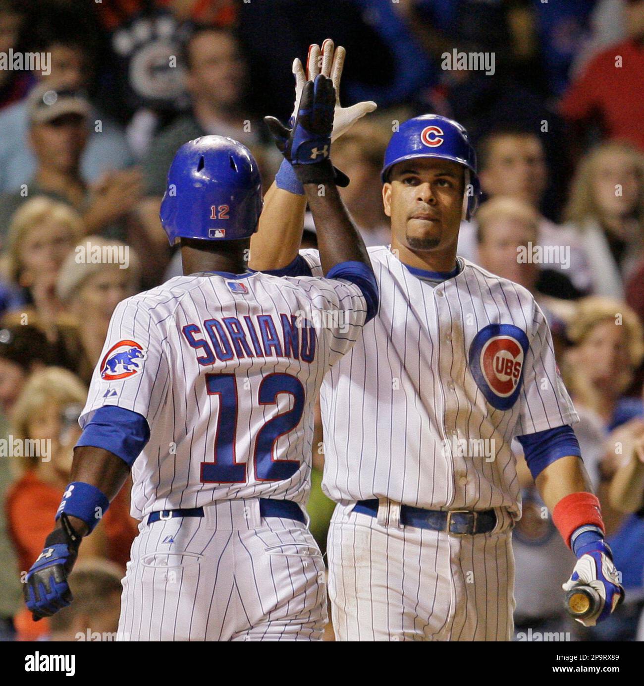 Florida Marlins' Juan Pierre is congratulated by teammate Derrek